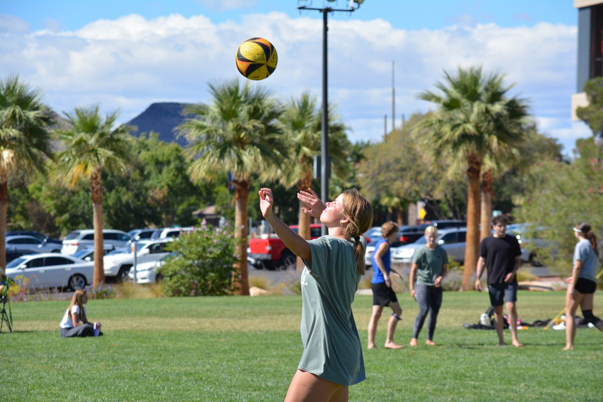 Player serving at OVCU grass volleyball